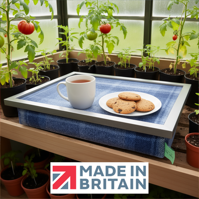 The Border lap tray with tea and biscuits on it, shown in a greenhouse setting, alongside the Made in Britain logo.