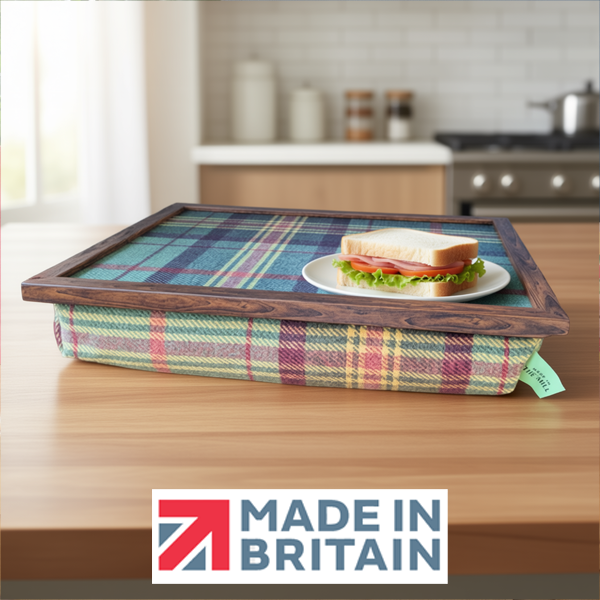 The Brittany Tweed lap tray with wooden frame and a cushioned base, shown on a kitchen counter with a sandwich on a plate, alongside the Made in Britain logo.