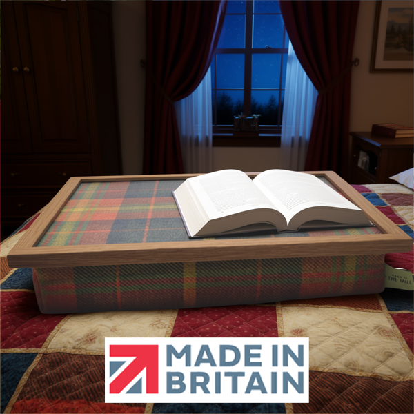 The Dachshund lap tray with an open book on it, displayed in a cosy bedroom, alongside the Made in Britain logo.