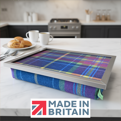 The Shiba Tweed lap tray with silver frame, displayed on a kitchen counter with pastries, alongside the Made in Britain logo.