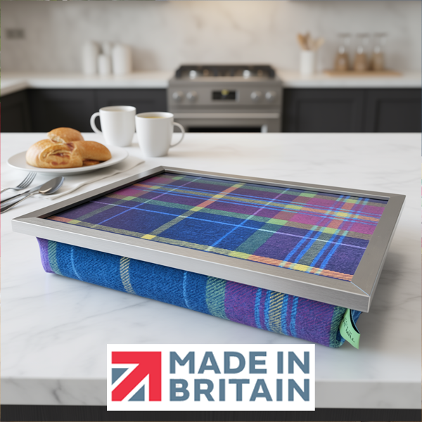 The Shiba Tweed lap tray with silver frame, displayed on a kitchen counter with pastries, alongside the Made in Britain logo.