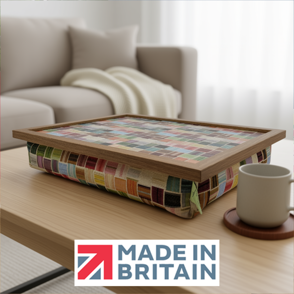 The colourful Sintra Patterned lap tray with wooden frame and a cushioned base, displayed in a cosy living room, alongside the Made in Britain logo.